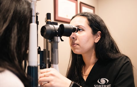 Optometrist and smiling patient during exam at Somerset in New Jersey