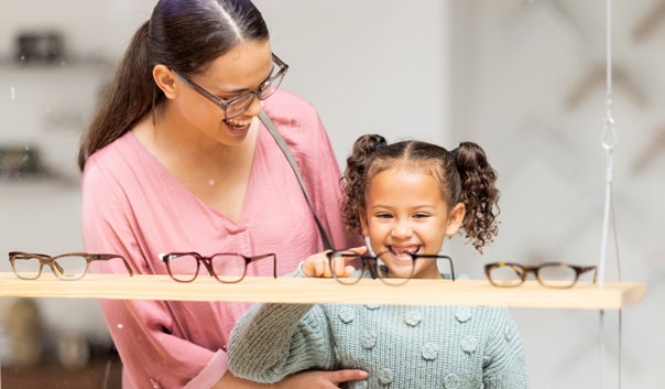 Mother and young girl selecting kid's glasses at Somerset in New Jersey