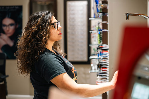 Woman choosing glasses and frames