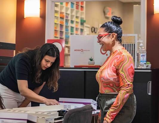 Woman looking at glasses with the optical team at Somerset Eye Care