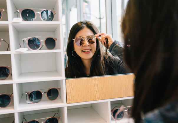 Woman trying on sunglasses