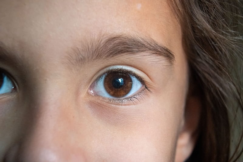 Child wearing glasses outdoors